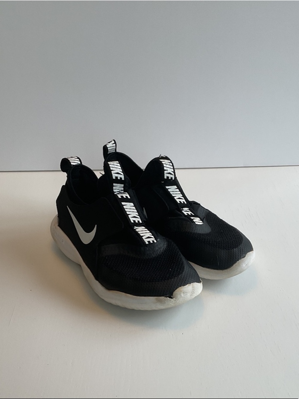 Nike Kids Black and White Slip-On Sneakers with Branded Pull Tabs